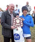 Look North weatherman Paul Mooney presents womens winner Michelle Holt (Sunderland Harriers) with the Prudhoe Miners Race Trophy.